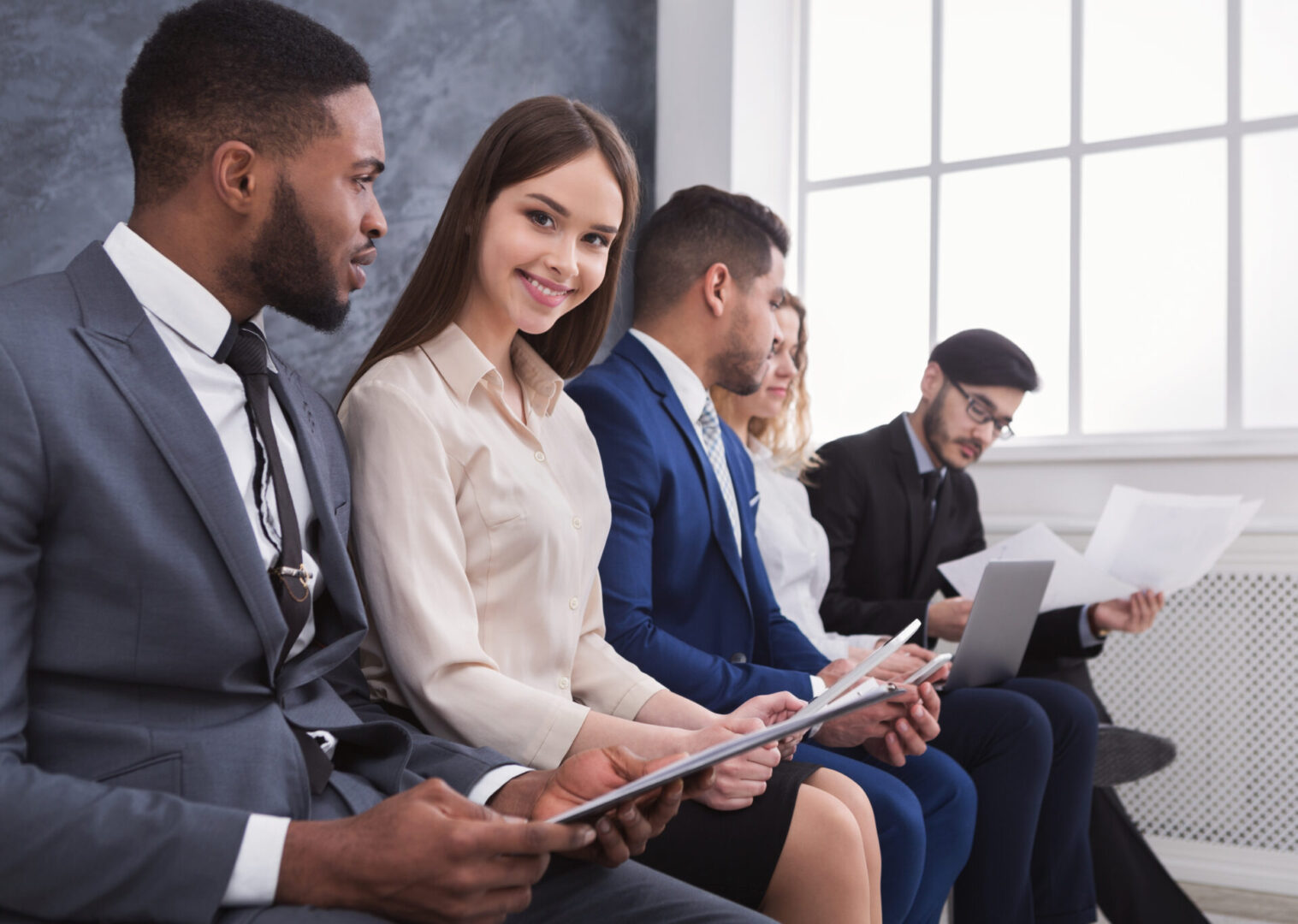 Young business people waiting in queue before job interview